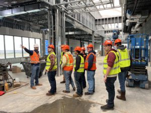 Build Montana students tour a worksite, led by a Project Manager with Sletten Construction Companies.
