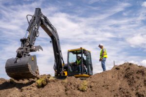 William Civil Construction instructs a student on the operation of an excavator in their workforce program, Williams Academy.